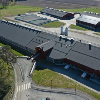 Aerial view of the VMS barn at DeLaval Hamra farm with surrounding buildings and fields